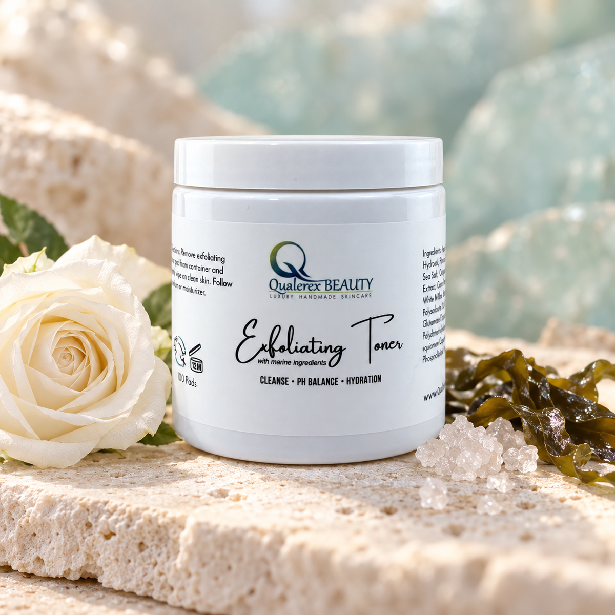 Qualerex Beauty Exfoliating Facial Toner Pads styled with a white rose, marine botanicals and mineral salt.